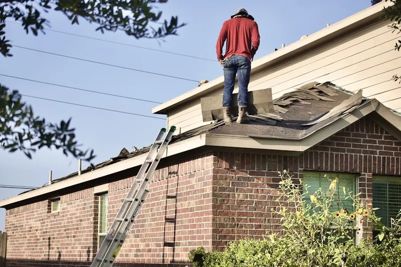 Professional roofer working on a residential roof in Kittyhawk
